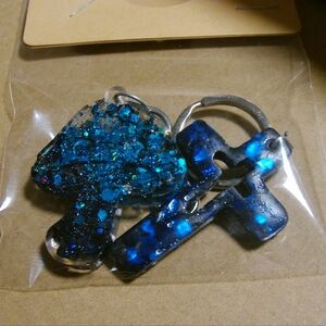 2 keychains blue black glitz mushroom/cross
